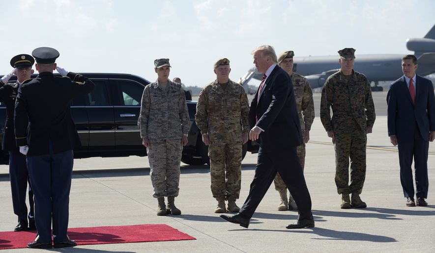 President Donald Trump arrives via Air Force One at MacDill Air Force Base in Tampa, Fla., Monday, Feb. 6, 2017. Trump stopped for a visit to the headquarters for U.S. Central Command and U.S. Special Operations Command at before returning to Washington. National Security Adviser Michael Flynn is at right, and Joint Chiefs Chairman Gen. Joseph Dunford is second from right. l (AP Photo/Susan Walsh)