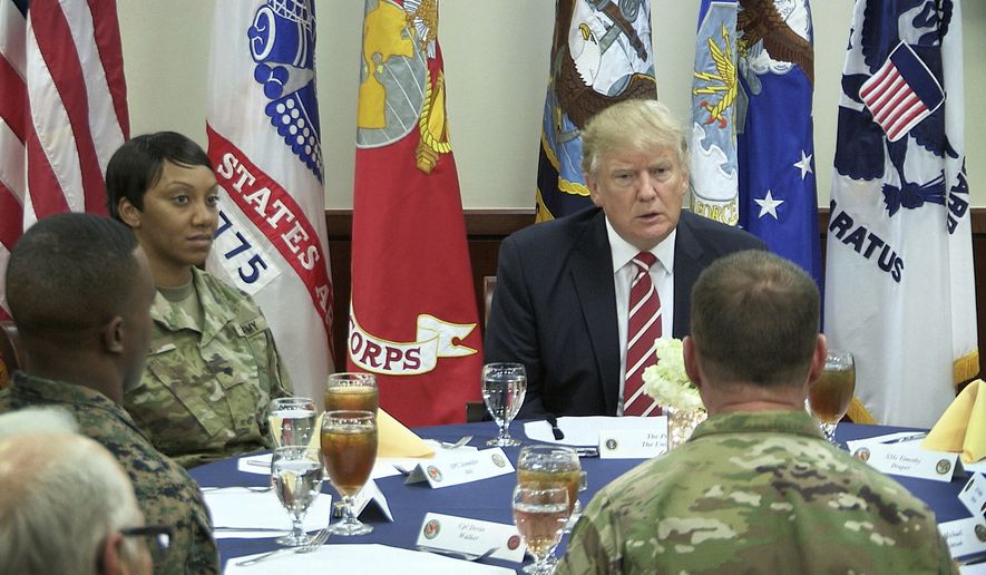 President Donald Trump talks with members of the military during a luncheon at U.S. Central Command at MacDill Air Force Base, Fla., Monday, Feb. 6, 2017. (James Borchuck/Tampa Bay Times via AP)