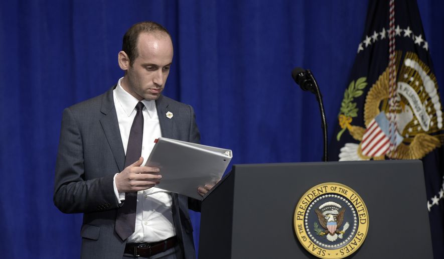 Senior policy adviser Stephen Miller places the remarks for President Donald Trump on the podium before Trump spoke to troops on a visit to U.S. Central Command and U.S. Special Operations Command at MacDill Air Force Base in Tampa, Fla., Monday, Feb. 6, 2017. (AP Photo/Susan Walsh)