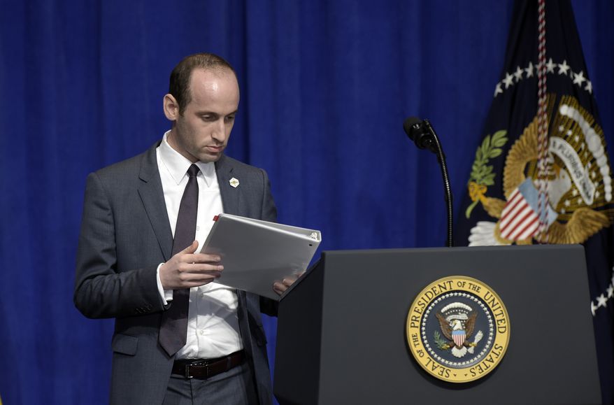 Senior policy adviser Stephen Miller places the remarks for President Donald Trump on the podium before Trump spoke to troops on a visit to U.S. Central Command and U.S. Special Operations Command at MacDill Air Force Base in Tampa, Fla., Monday, Feb. 6, 2017. (AP Photo/Susan Walsh)