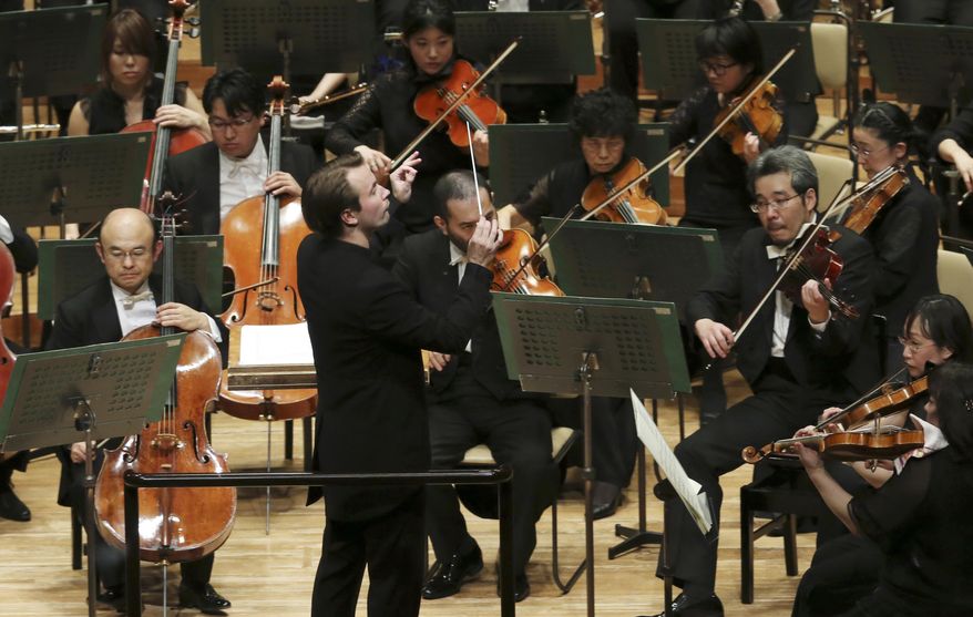 In this Jan. 21, 2017 photo, Finland's Pietari Inkinen conducts the Japan Philharmonic Orchestra during their concert at Suntory Hall in Tokyo. Japan’s love for classical music and Japanese acoustician Yasuhisa Toyota’s talent were evident at the recent Japan Philharmonic Orchestra performance of Bruckner’s “Symphony No. 8 in C minor.” Inkinen said the hall was so close to perfect any kind of piece could be played, inspiring the performers because listeners can feel the symphony “in their stomachs.” (AP Photo/Koji Sasahara)