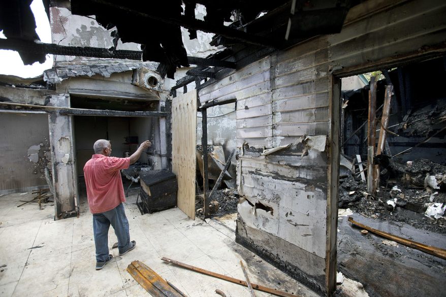 FILE - In a Thursday, Sept. 15, 2016, file photo, Farhad Khan, who has attended the Islamic Center of Fort Pierce for more than seven years, shows members of the media its charred remains, in Fort Pierce, Fla. Joseph Schneider, an ex-convict who investigators say confessed to setting fire to the mosque tied to the Orlando nightclub shooter, pleaded no contest to those charges, Monday, Feb. 6, 2017. (AP Photo/Wilfredo Lee, File)