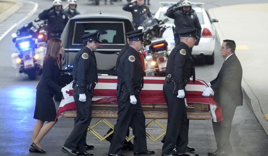 Police officers escort the remains of fallen Metro police Officer Eric Mumaw into Cornerstone Church in Nashville, Tenn., Monday, Feb. 6, 2017, for his memorial service. Mumaw died Feb. 2 when he went into the Cumberland River while trying to save a woman. (Shelley Mays/The Tennessean via AP)