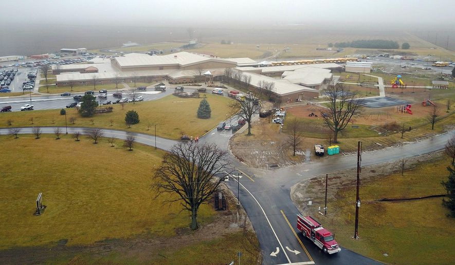 FILE- In this Jan. 20, 2017, file photo authorities investigate the scene after a shooting at West Liberty-Salem Schools in Champaign County, Ohio. The 16-year-old victim of the Ohio school shooting has returned home after several days in the hospital as a court case continues against the suspect. Ryan Cole, the father of victim Logan Cole, said in a Facebook post Saturday, Feb. 4, that Logan was home. (Eric Dietrich/Dayton Daily News via AP, File)