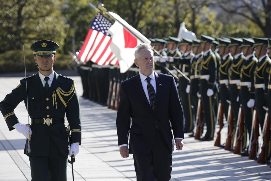 In this Saturday, Feb. 4, 2017 photo, U.S. Defense Secretary Jim Mattis, right, is escorted to inspect an honor guard at Defense Ministry in Tokyo. Mattis on Friday reassured two key U.S. treaty allies, South Korea and Japan, that President Donald Trump, who has raised doubts about the value of such partnerships, is fully committed to defending them. (AP Photo/Eugene Hoshiko, File)