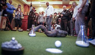 Arizona Cardinals wide receiver Larry Fitzgerald, center, putts a hole-in-one on an indoor putting green during the Chevron&#39;s 7th annual $100,000 Shoot-Out in the Champions vs Champions to kick off the AT&amp;T National Pro-Am golf tournament on Tuesday, Feb. 7, 2017, in Pebble Beach, Calif. Since 2013, Chevron has provided over $500,000 to local nonprofits and education organizations through this event. (Tony Avelar/AP Images for Chevron)
