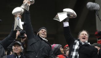 New England Patriots quarterback Tom Brady holds up Super Bowl trophies along with head coach Bill Belichick, right, and team owner Robert Kraft, left, during a rally Tuesday, Feb. 7, 2017, in Boston, to celebrate Sunday&#39;s 34-28 win over the Atlanta Falcons in the NFL Super Bowl 51 football game in Houston. (AP Photo/Elise Amendola)