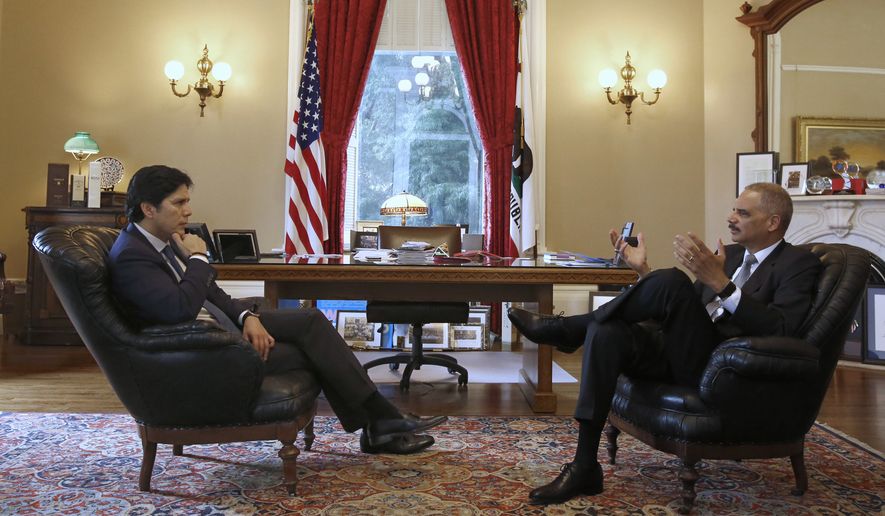 Senate President Kevin de Leon, D-Los Angeles, left, mets with former U.S. Attorney General Eric Holder, Tuesday, Feb. 7, 2017, in Sacramento, Calif. Holder has been hired by Democratic leaders of California&#39;s Legislature to represent them in legal issues against President Donald Trump and his administration. Holder met with de Leon, Assembly Speaker Anthony Rendon, D- Paramount, and Gov. Jerry Brown during his visit. (AP Photo/Rich Pedroncelli)