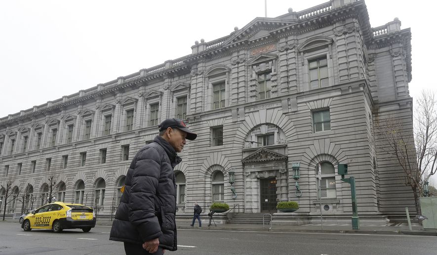 A man walks outside of the 9th U.S. Circuit Court of Appeals in San Francisco, Tuesday, Feb. 7, 2017. President Donald Trump&#39;s travel ban faced its biggest legal test yet Tuesday as a panel of federal judges prepared to hear arguments from the administration and its opponents about two fundamentally divergent views of the executive branch and the court system. (AP Photo/Jeff Chiu)