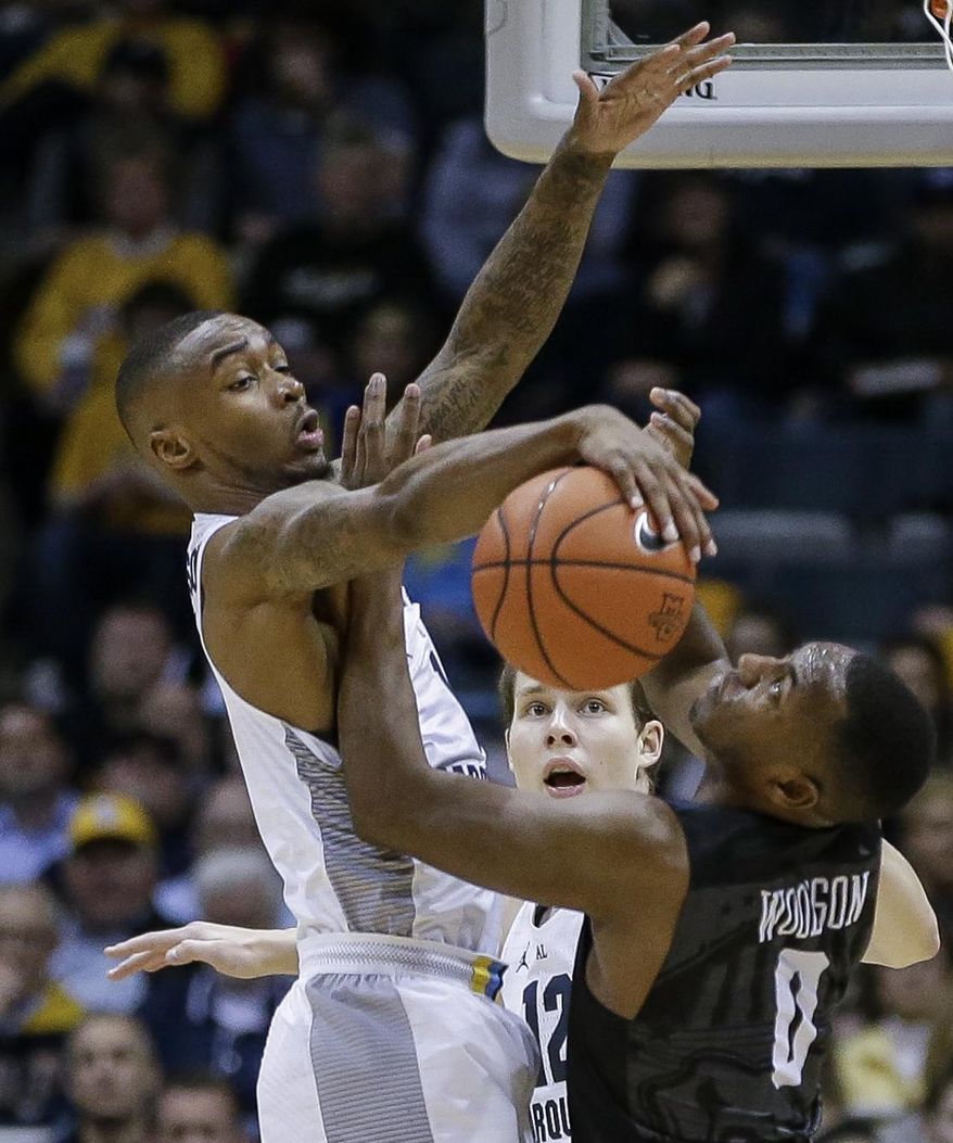 Marquette's Duane Wilson blocks the shot of Butler's Avery Woodson during the first half of an NCAA college basketball game Tuesday, Feb. 7, 2017, in Milwaukee. (AP Photo/Tom Lynn)