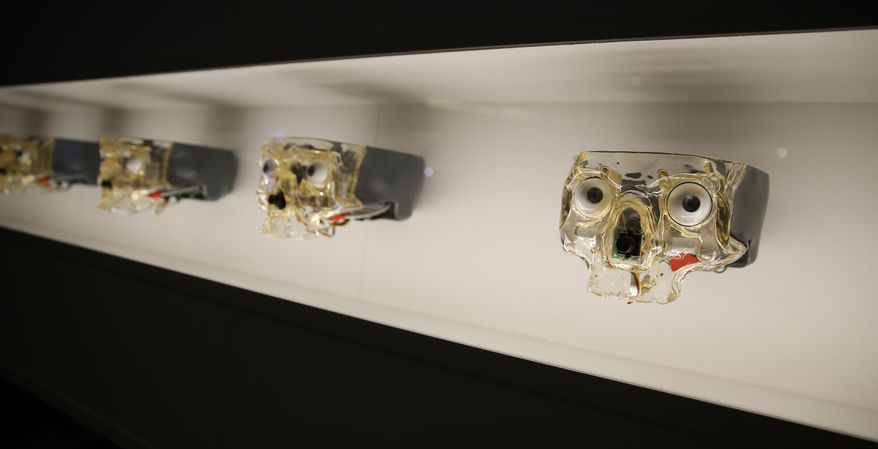 Artwork by Canadian Louis-Philippe Demers, which shows a wall of artificial skulls with robotic eyes which follow the motion of a visitor, during a press preview for the Robots exhibition held at the Science Museum in London, Tuesday, Feb. 7, 2017. The exhibition which shows 500 years of mechanical and robotic advances is open to the public form Feb. 8 through to Sept. 3. (AP Photo/Alastair Grant)