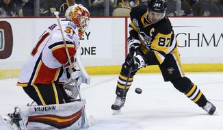 Pittsburgh Penguins&#39; Sidney Crosby (87) can&#39;t get a shot past Calgary Flames goalie Chad Johnson during the second period of an NHL hockey game in Pittsburgh, Tuesday, Feb. 7, 2017. (AP Photo/Gene J. Puskar)
