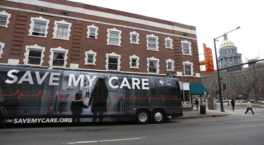 The bus of the national Save My Care Bus Tour idles near the state Capitol as supporters of the Affordable Care Act who are also opponents of Colorado's GOP-led plan to undo Colorado's state-run insurance exchange gather for a rally on the state Capitol steps in Denver, Tuesday, Feb. 7, 2017. A bill being heard in the Senate Finance Committee would abolish the state-run health insurance exchange. (AP Photo/Brennan Linsley)