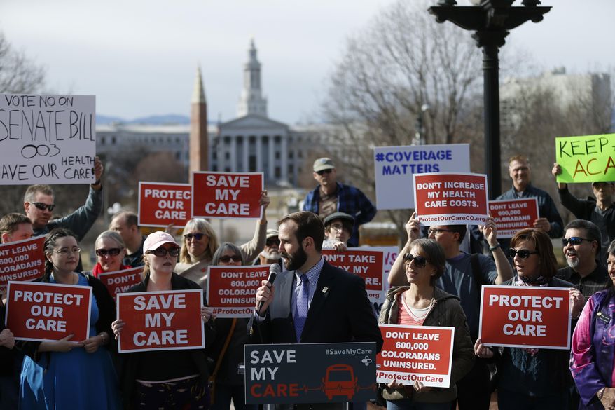 Colorado AFL-CIO Executive Director Sam Gilchrist speaks to supporters of the Affordable Care Act, who are also opponents of Colorado's GOP-led plan to undo Colorado's state-run insurance exchange, during a rally organized by the national Save My Care Bus Tour, on the state Capitol steps in Denver, Tuesday, Feb. 7, 2017. A bill being heard in the Senate Finance Committee Tuesday would abolish the state-run health insurance exchange. (AP Photo/Brennan Linsley)