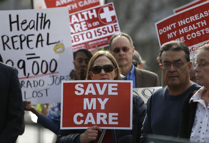 Supporters of the Affordable Care Act, who are also opponents of Colorado's GOP-led plan to undo Colorado's state-run insurance exchange gather for a rally organized by the national Save My Care Bus Tour, on the state Capitol steps in Denver, Tuesday, Feb. 7, 2017. A bill being heard in the Senate Finance Committee Tuesday would abolish the state-run health insurance exchange. (AP Photo/Brennan Linsley)
