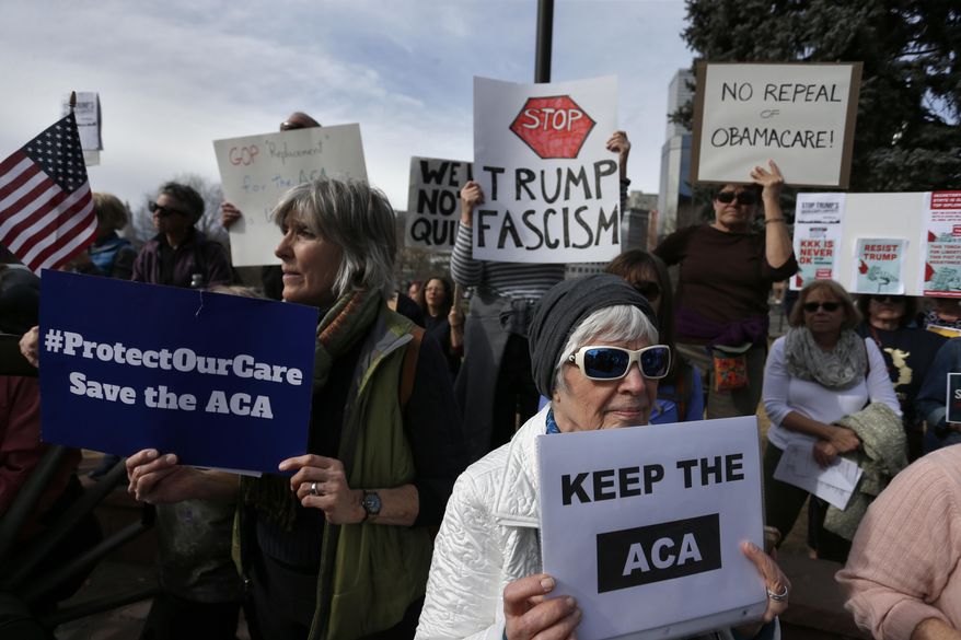 Supporters of the Affordable Care Act, who are also opponents of Colorado's GOP-led plan to undo Colorado's state-run insurance exchange, gather for a rally organized by the national Save My Care Bus Tour, on the state Capitol steps in Denver, Tuesday, Feb. 7, 2017. A bill being heard in the Senate Finance Committee Tuesday would abolish the state-run health insurance exchange. (AP Photo/Brennan Linsley)