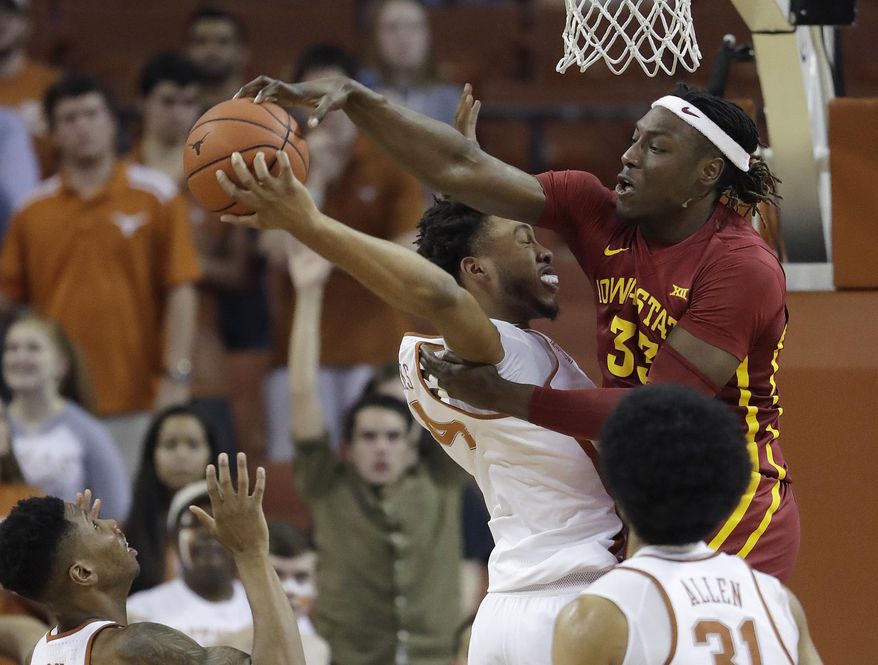 Texas center James Banks (4) and Iowa State forward Solomon Young (33) battle for a rebound during the second half of an NCAA college basketball game, Tuesday, Feb. 7, 2017, in Texas, Texas. Texas won 67-65. (AP Photo/Eric Gay)