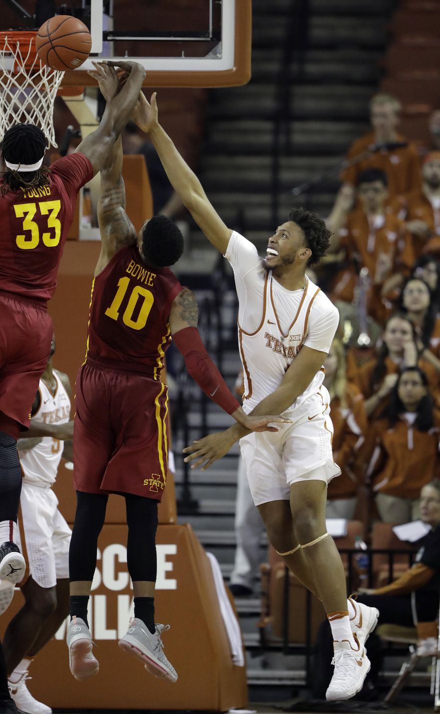 Texas center James Banks, right, is blocked by Iowa State defenders Solomon Young (33) and Darrell Bowie (10) as he tires to score during the first half of an NCAA college basketball game, Tuesday, Feb. 7, 2017, in Texas, Texas. (AP Photo/Eric Gay)