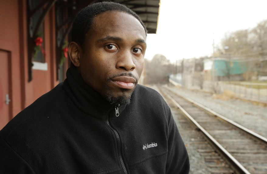 In this Thursday, Dec. 8, 2016 photo Charm Howie, of Providence, R.I., stands for a photograph, in Woonsocket, R.I. Howie is one of several residents alleging racially biased and overly aggressive policing by what critics have come to call the "third shift terror squad" of Providence officers who patrol the city's South Side at night. Howie, a black former police cadet, has a unique relationship with the white officers who arrested him after a traffic stop last year: he was their former classmate at an academy he says he was bullied into leaving. (AP Photo/Steven Senne)