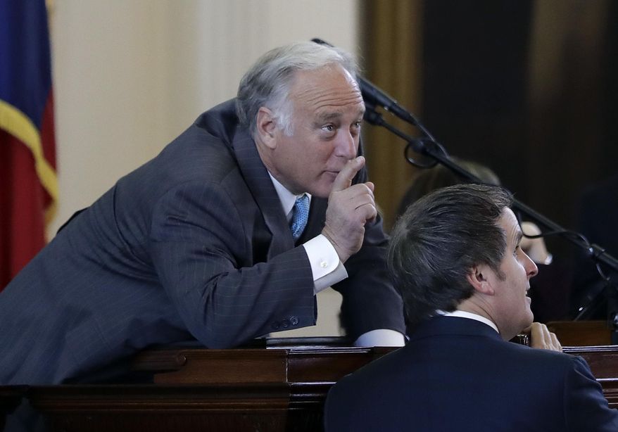 Texas Sen. Kirk Watson, D-Austin, left, talks with Sen. Bryan Hughes, R-Tyler, debate an anti-sanctuary cities proposal in the Senate Chamber at the Texas Capitol, Tuesday, Feb. 7, 2017, in Austin, Texas. (AP Photo/Eric Gay)