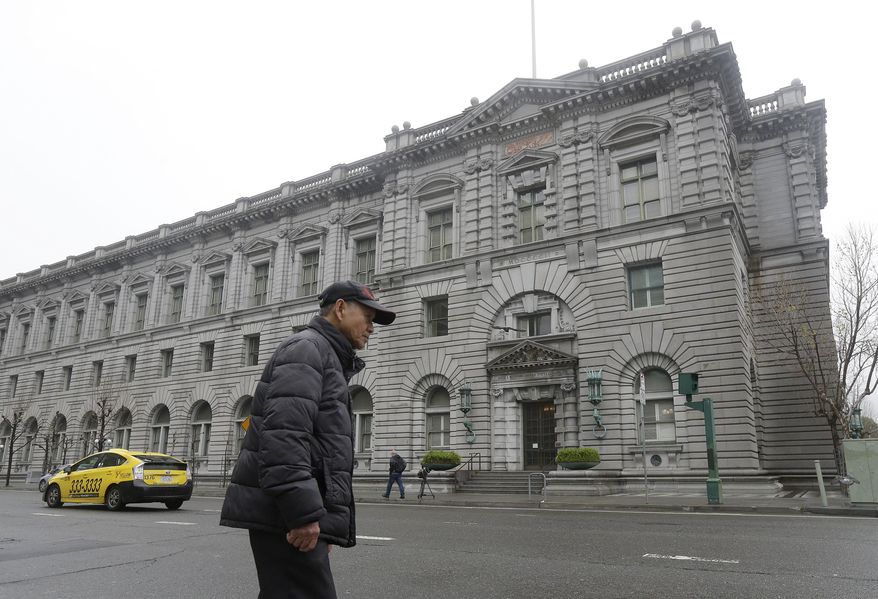 A man walks outside of the 9th U.S. Circuit Court of Appeals in San Francisco, Tuesday, Feb. 7, 2017. President Donald Trump's travel ban faced its biggest legal test yet Tuesday as a panel of federal judges prepared to hear arguments from the administration and its opponents about two fundamentally divergent views of the executive branch and the court system. (AP Photo/Jeff Chiu)