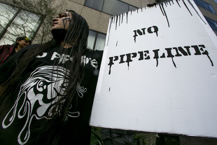 Lance Browneyes joins opponents of the Dakota Access pipeline protesting around the country, in response to the Army Corps of Engineers saying it will clear the way for completion of the disputed $3.8 billion project to carry North Dakota oil to Illinois, outside the Army&#39;s offices in Los Angeles Wednesday, Feb. 8, 2017. Dallas-based Energy Transfer Partners, ETP on Wednesday got final permission from the Army to proceed with a crossing of the Missouri River in southern North Dakota. The tribe fears a pipeline leak could contaminate its drinking water. (AP Photo/Damian Dovarganes)