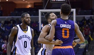 Memphis Grizzlies guard Andrew Harrison, center, gets between Phoenix Suns forward Marquese Chriss (0) and Grizzlies forward JaMychal Green, left, during an altercation on the court in the second half of an NBA basketball game Wednesday, Feb. 8, 2017, in Memphis, Tenn. (AP Photo/Brandon Dill)