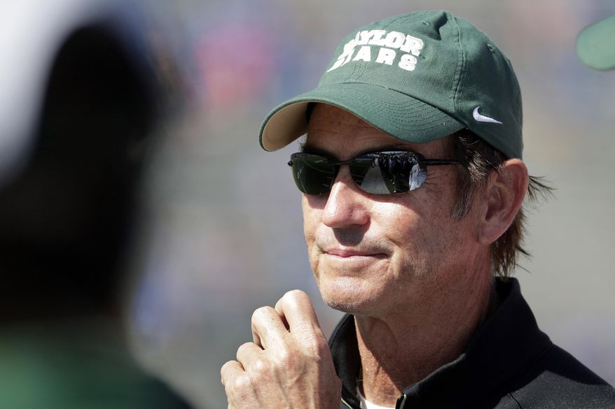 FILE - In this Oct. 10, 2015, file photo, Baylor head coach Art Briles watches during the second half of an NCAA college football game against Kansas in Lawrence, Kan. The Big 12  conference said Wednesday, Feb. 8, 2017,  it will withhold 25 percent of Baylor&#x27;s share of conference revenue until an outside review of the athletic department determines whether the school is in compliance with conference regulations and Title IX guidelines following its sexual assault scandal that has rocked the school. Baylor fired coach Art Briles last year and parted ways with university President Ken Starr and athletic director Ian McCaw after an investigation by a law form found allegations of sexual assault brought to the school were not dealt with appropriately. (AP Photo/Charlie Riedel, File)