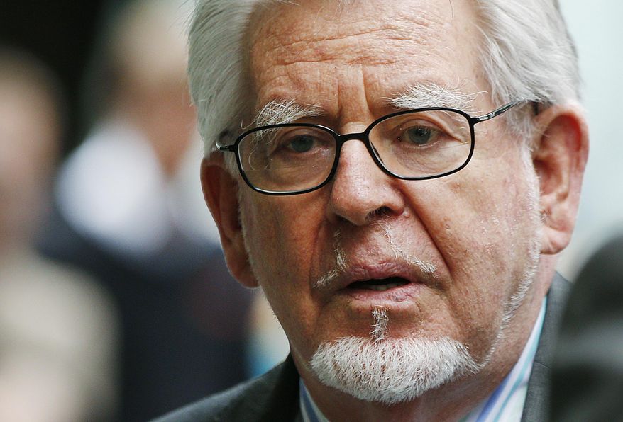FILE - In this Monday, June 30, 2014 file photo, veteran entertainer Rolf Harris leaves the Southwark Crown Court in London. Harris, who is serving a prison sentence for a string of sexual abuses against young girls, has been cleared on another three charges of sexual assault. He was found not guilty Tuesday, Feb. 7, 2017 of three of seven assaults said to have taken place over four decades. (AP Photo/Lefteris Pitarakis, file)