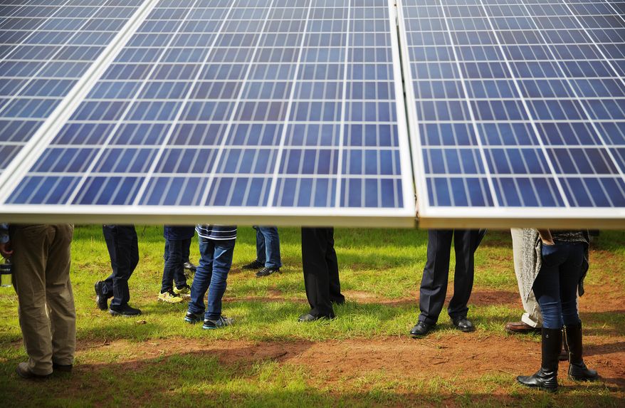 Guests tour a solar panel project built on 10 acres of farmland that former President Jimmy Carter owns in his hometown of Plains, Ga., Wednesday, Feb. 8, 2017. Carter leased the land to Atlanta-based SolAmerica Energy, which owns, operates, and sells power generated from solar cells. The company estimates the project will provide more than half of the power needed in this town of 755 people. (AP Photo/David Goldman) **FILE**