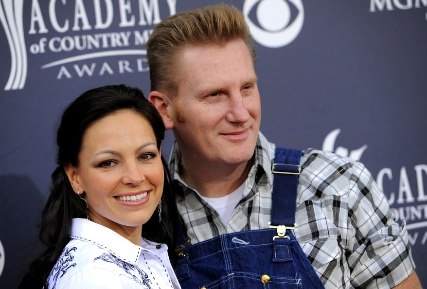 FILE - In this April 3, 2011, file photo, Joey Martin Feek, left, and husband Rory Lee Feek, of "Joey + Rory," arrive at the Annual Academy of Country Music Awards in Las Vegas. Joey Feek, who was diagnosed with stage four cancer, told her husband Rory that if they ever got another chance to be nominated, he should attend the ceremony. She died on March 4 at the age of 40, but she got her wish. Joey + Rory are nominated this year for best roots gospel album for their record “Hymns.” (AP Photo/Chris Pizzello, File)