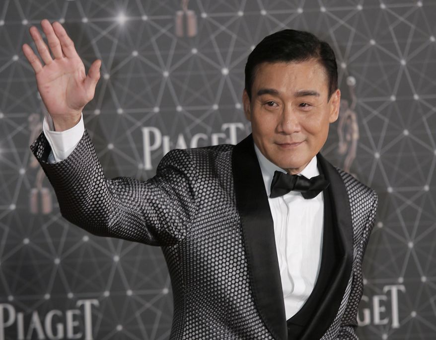 FILE: In this Sunday, April 3, 2016, file photo, Hong Kong actor Tony Leung Ka-fai poses on the red carpet of the Hong Kong Film Awards in Hong Kong. Leung is trailing closely with 10 nominations is the cop thriller “Cold War II,” nominated as best film, screenplay, cinematography and best actor in the Hong Kong Film Awards on April 9. (AP Photo/Vincent Yu, File)
