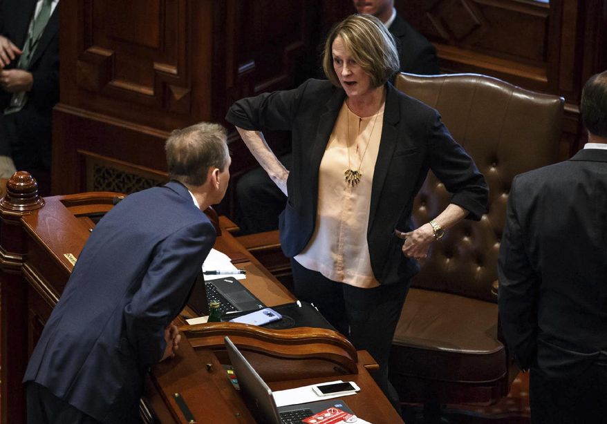 Illinois Senate Minority Leader Christine Radogno, R-Lemont, talks with Illinois State Sen. Dale Righter, R-Mattoon, on the Senate floor prior to Senate Bill 11, the pension reform bill, coming up for a vote at the Illinois State Capitol, Wednesday, Feb. 8, 2017, in Springfield, Ill. The Illinois Senate's attempt Wednesday to bust open a longstanding budget stalemate did not bode well for ending the nation's longest state-budget drought since World War II. (Justin L. Fowler/The State Journal-Register via AP)