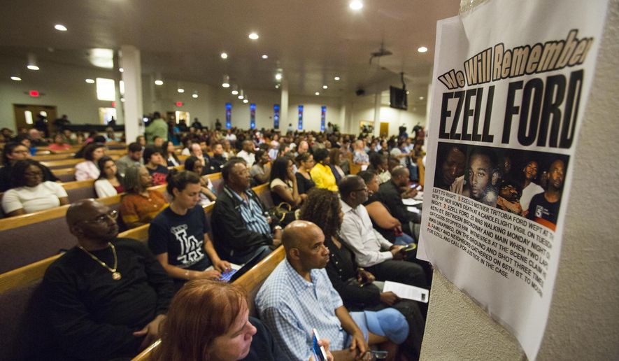 FILE - In this Aug. 19, 2014, file photo, a poster reads &amp;quot;We Will Remember Ezell Ford&amp;quot; at Paradise Baptist Church during a community forum in Los Angeles, to discuss the police shooting of 25-year-old Ezell Ford. The city of Los Angeles will pay $1.5 million to settle a lawsuit brought by the family of  Ford,  who was killed by police during a struggle over an officer&#39;s gun. The settlement was approved Wednesday, Feb. 8, 2017, by the Los Angeles City Council after Ezell Ford&#39;s family brought a civil rights lawsuit against the city. (AP Photo/Ringo H.W. Chiu, File)