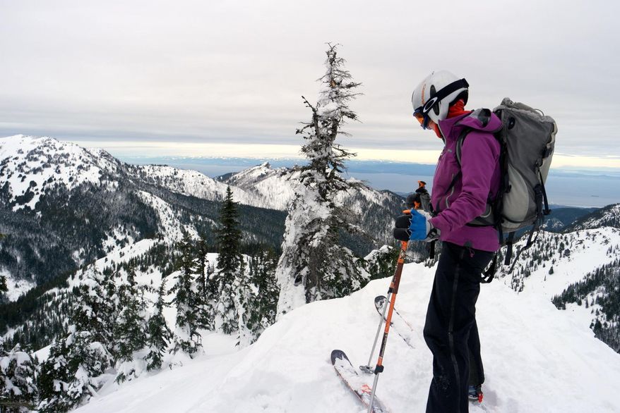 This photo taken Jan. 7, 2017, shows Telemark skier Meghan Ahearn preparing to drop in off of Sunrise Ridge in Olympic National Park, Wash. (Caitlin Moran / The Seattle Times via AP)