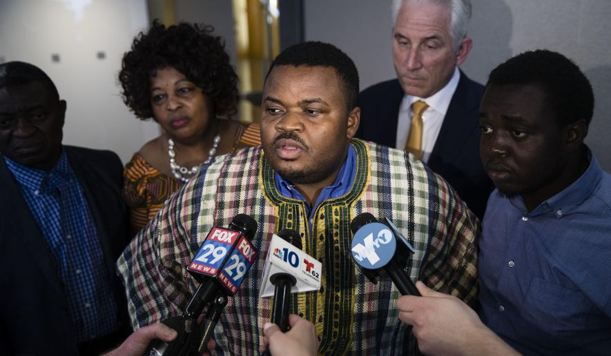 Francis Sankoh, who's mother Roseline Conteh died in a 2013 building collapse, speaks with members of the media during a news conference in Philadelphia, Wednesday, Feb. 8, 2017. Lawyers for 19 people killed or injured in a Philadelphia building collapse reached a $227 million settlement with several defendants as the jury, which already had found them liable, deliberated Wednesday on damages. Six people were killed and 13 injured when a towering brick wall left unbraced during a demolition project crushed an adjacent Salvation Army store in 2013. (AP Photo/Matt Rourke)