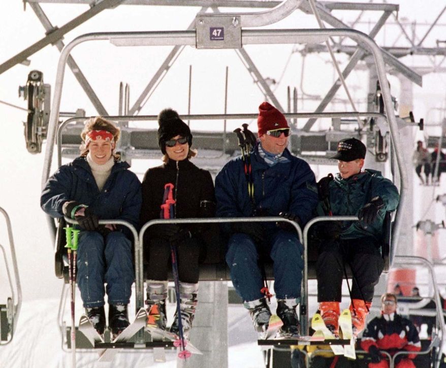 FILE - A Jan. 1, 1997 file photo of Britain&#39;s Prince Charles, 2nd right, with his younger son Prince Harry, right, joined in a ski lift by Santa Sebag Montefiore, with her sister, and Prince Charles&#39; goddaughter, Tara Palmer-Tomkinson, on the way up the Gotschnabahn ski runs above Klosters, Switzerland. Palmer-Tomkinson,has been found dead in her London home. She was 45. Prince Charles said in a statement Wednesday, Feb.8, 2017, that he and his wife, the Duchess of Cornwall, are “deeply saddened” by news of her death. The cause of death was not immediately clear, though she revealed last year that she had been diagnosed with a brain tumor. (John Stillwell/PA via AP, File)