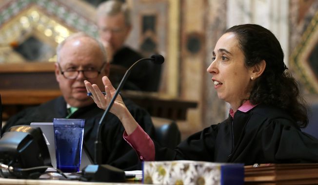 FILE - In this Sept. 18, 2014, file photo, Circuit Judge Michelle T. Friedland, right, gestures while questioning Barry Bonds&#x27; attorney, Dennis Riordan, before an 11-judge panel of the 9th U.S. Circuit Court of Appeals in San Francisco. Friedland is one of three judges on the San Francisco-based 9th Circuit Court of Appeals deciding whether to reinstate President Donald Trump&#x27;s travel ban. (AP Photo/Eric Risberg, Pool, file)