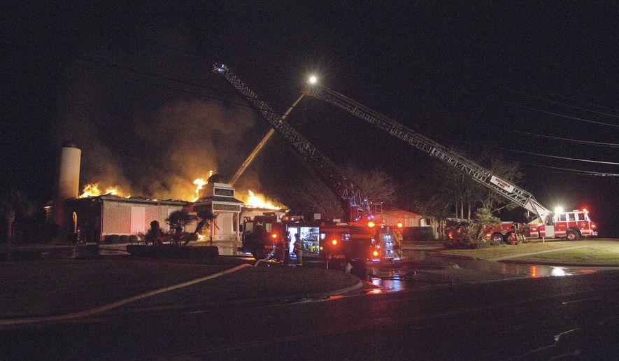 FILE - In a Saturday, Jan. 28, 2017 file photo, Victoria firefighters respond to a fire at the Islamic Center of Victoria, in Victoria, Texas. Federal investigators say the fire that destroyed a South Texas mosque has been ruled arson and at this time there's no evidence of a hate crime. A $30,000 reward was offered Wednesday, Feb. 8, 2017, for information leading to arrests and indictments over the pre-dawn fire at the Victoria Islamic Center. (Barclay Fernandez/The Victoria Advocate via AP, File)