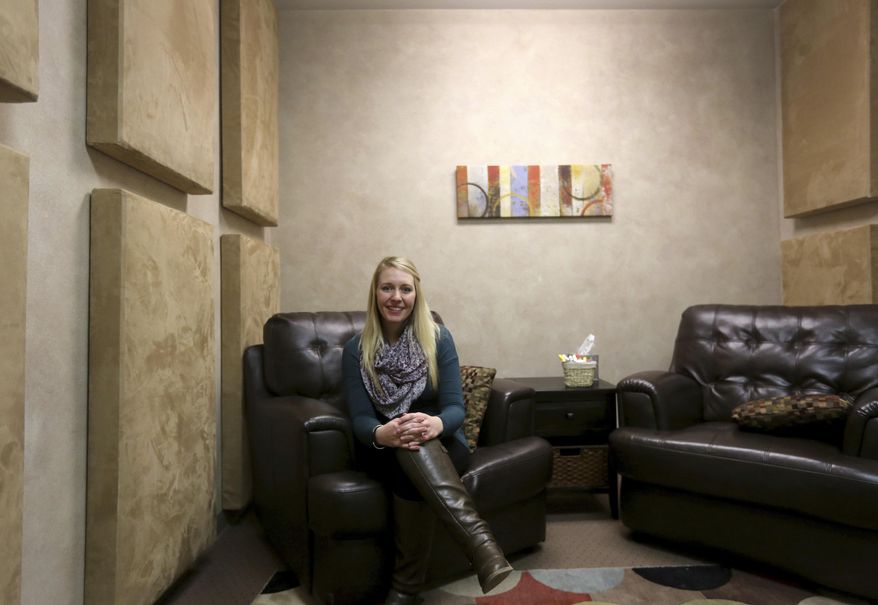 Forensic interviewer and therapist Baleigh Hite poses in an interview room Jan. 23, 2017 at the Children's Advocacy Project in Casper, Wyo. Three child advocacy facilities have seen their funding change repeatedly over the past few years as state agencies were asked to slash expenses. (Dan Cepeda, Casper Star-Tribune via AP)