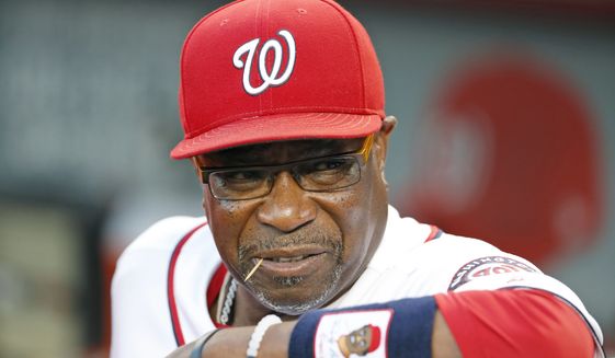 FILE - In this Sept. 13, 2016, file photo, Washington Nationals manager Dusty Baker pauses in the dugout before a baseball game against the New York Mets at Nationals Park in Washington. Instead of revamping their roster after yet another early playoff exit, the Washington Nationals head to spring training next week counting on a bounce-back year from Bryce Harper and a full season from Stephen Strasburg. (AP Photo/Alex Brandon, File)
