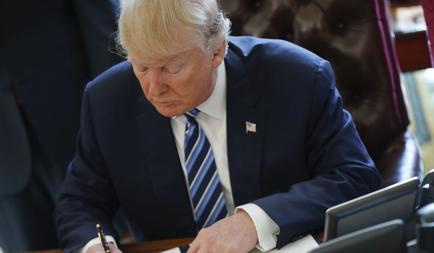 President Donald Trump signs an executive order in the Oval Office of the White House in Washington, Thursday, Feb. 9, 2017. Trump signed three executive orders related to reducing crime. (AP Photo/Pablo Martinez Monsivais) **FILE**