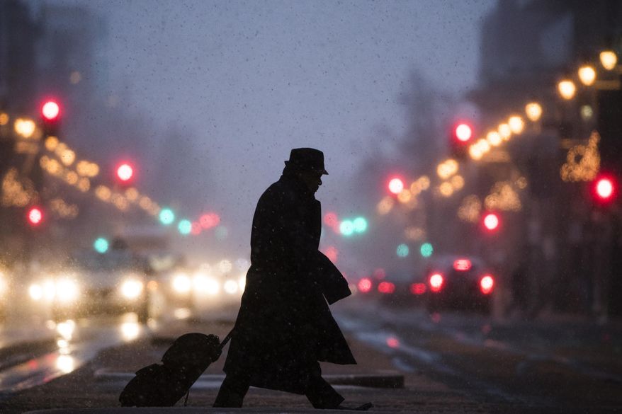 A pedestrian crosses South Broad Street during a winter storm in Philadelphia, Thursday, Feb. 9, 2017. A powerful, fast-moving storm swept through the northeastern U.S. Thursday, making for a slippery morning commute and leaving some residents bracing for blizzard conditions. (AP Photo/Matt Rourke)