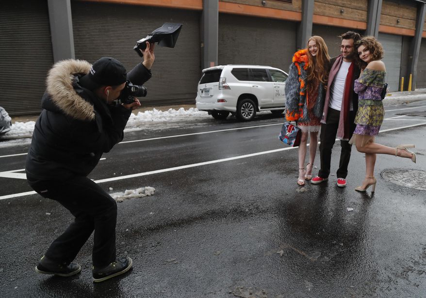 A fashion photographer photographs guests arriving for a fashion show at Skylight Clarkson Square during Fashion Week, Thursday, Feb. 9, 2017, in New York. (AP Photo/Julie Jacobson)