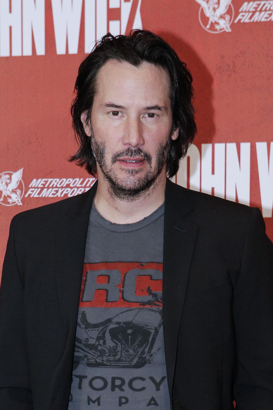 Actor Keanu Reeves poses for the media as he arrives for the French premiere for 'John Wick 2' in Paris, Tuesday, Feb. 7, 2017. (AP Photo/Kamil Zihnioglu)