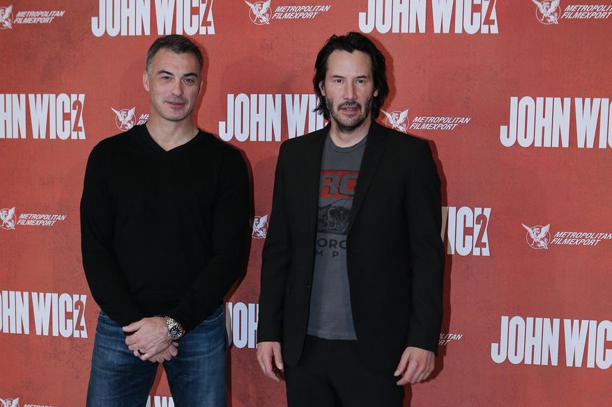 Director Chad Stahelski, left, and actor Keanu Reeves pose for the media as they arrive for the French premiere for 'John Wick 2' in Paris, Tuesday, Feb. 7, 2017. (AP Photo/Kamil Zihnioglu)