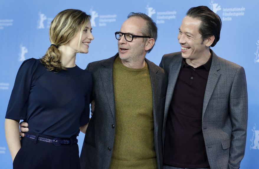 From left, actress Cecile de France, director Etienne Comar and actor Reda Kateb pose for the photographers during a photo call for the film 'Django' at the 2017 Berlinale Film Festival in Berlin, Germany, Thursday, Feb. 9, 2017. (AP Photo/Michael Sohn)