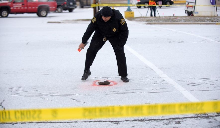 A sheriff's deputy marks evidence at the scene where a 4-year-old girl died after being struck by a vehicle while walking to school with her mother Thursday, Feb. 9, 2017 in Flint, Mich. (Mark Felix/The Flint Journal-MLive.com via AP)