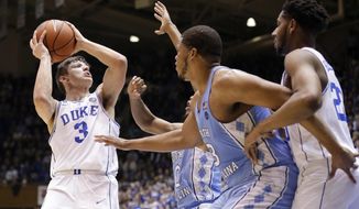 Duke&#39;s Grayson Allen (3) looks to shoot while North Carolina&#39;s Nate Britt, rear, and Kennedy Meeks (3) defend as Duke&#39;s Marques Bolden watches at right during the first half of an NCAA college basketball game in Durham, N.C., Thursday, Feb. 9, 2017. (AP Photo/Gerry Broome)