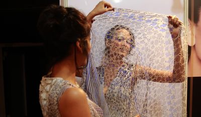 In this Feb. 1, 2017 photo, Anjali Lama, a transgender model from Nepal, holds a scarf up with another model as they wait to walk the ramp during Lakme Fashion week in Mumbai, India. Growing up as the fifth son in a poor farming family in rural Nepal the dream to be a fashion model came late in life. First came a long, painful struggle to accept that he felt deeply female. It was a chance encounter with a group of transgender women that turned Lama's life around by putting her in touch with the Blue Diamond Society, an advocacy group for Nepal's LGBT community. In 2005 she came out to her friends and family as a transgender woman. (AP Photo/Rafiq Maqbool)